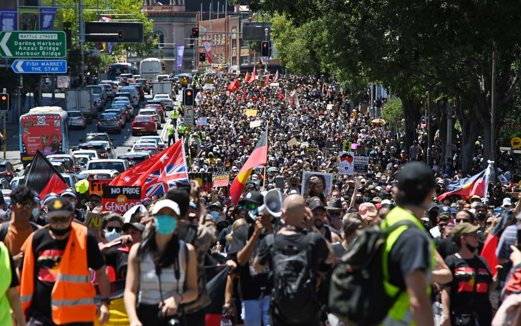 Protesters take part in an "Invasion Day" demonstration on Australia Day in Sydney on January 26, 2022. (Photo by Steven Saphore / AFP) (Photo by STEVEN SAPHORE/AFP via Getty Images)