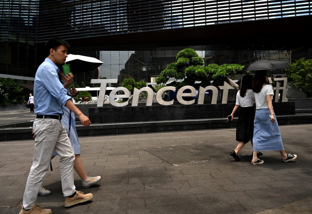 People walking past the Tencent headquarters in the southern Chinese city of Shenzhen, in Guangdong province.