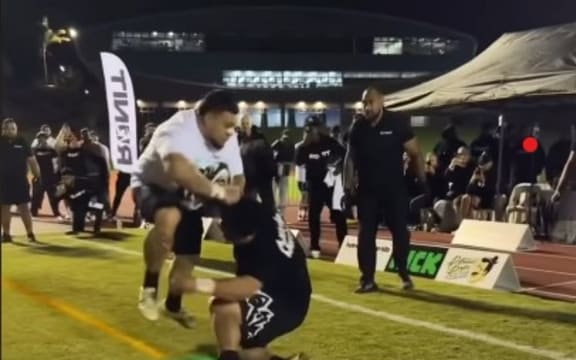 Two men collide during a 'Run it' sporting event in Auckland.