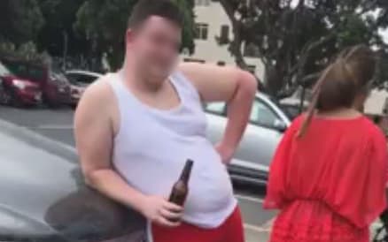 A screengrab from the video posted on social media of a woman challenging the tourists for littering at Takapuna Beach.