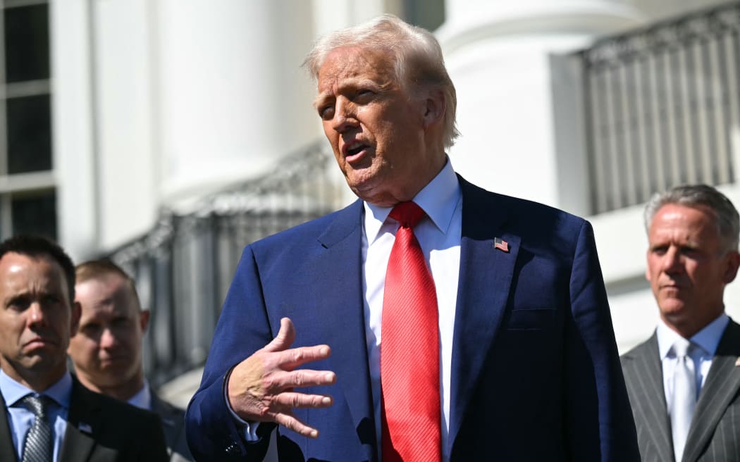 US President Donald Trump speaks during a photo opportunity with autoracing officials and champions on the South Portico of the White House on April 9, 2025, in Washington,