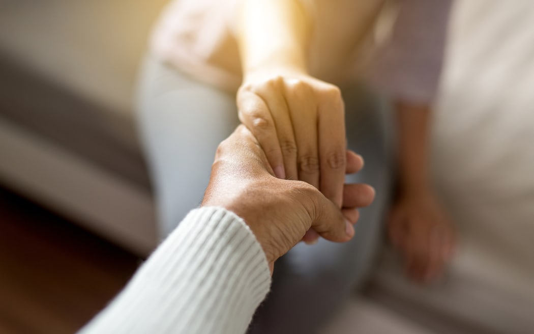 Man giving hand to depressed woman,Psychiatrist holding hands patient,Meantal health care concept,Selective focus