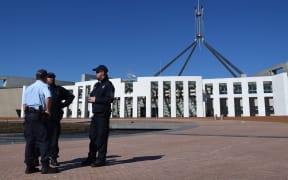 Australian Federal Police officers are seen outside Parliament House in Canberra, after 'chatter' about a possible terrorist attack