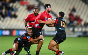 Quinten Strange of the Crusaders is tackled by Xavier Roe of the Chiefs and Anton Lienert-Brown of the Chiefs during the Super Rugby Pacific match, Crusaders Vs Chiefs, at the Apollo Projects Stadium, Christchurch, New Zealand, 29th March 2024. Copyright photo: John Davidson / www.photosport.nz