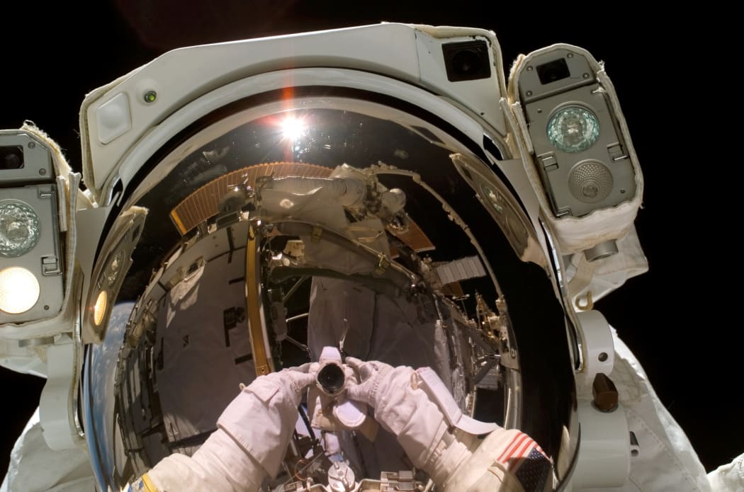 Astronaut Heidemarie M. Stefanyshyn-Piper, STS-115 mission specialist, took this self-portrait . The mission specialist had just unstowed the forward Solar Array Blanket Box (SABB) when this portrait, taken on a Sept. 12 space walk that marked the resumption of construction on the International Space Station.