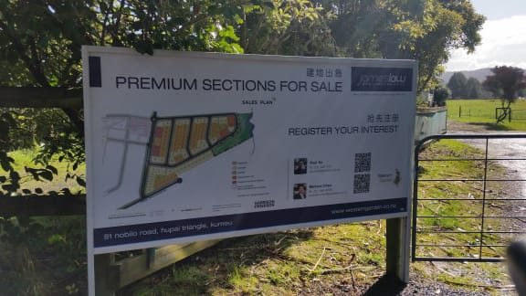 A sign posted at the Huapai Triangle, offering ‘premium sections’.