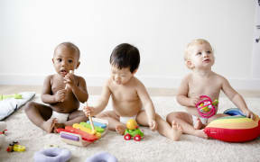 Babies playing together in a play room