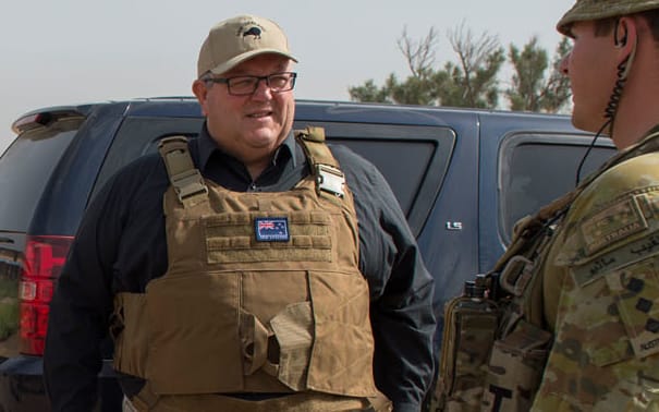 Chief of Defence Force Tim Keating, left, Labour leader Andrew Little and Defence Minister Gerry Brownlee, fourth from left, talk to New Zealand and Australian troops in Iraq.