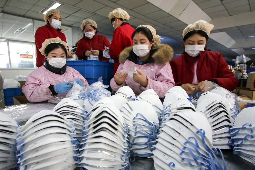 Workers producing face masks at a factory in Handan on January 22, 2020.