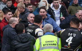 Salford players scuffle with their own fans.