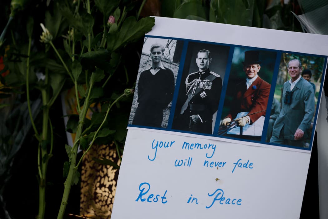 A message of tribute for Britain's Prince Philip is seen amid flowers outside Buckingham Palace in London, United Kingdom on April 09, 2021.