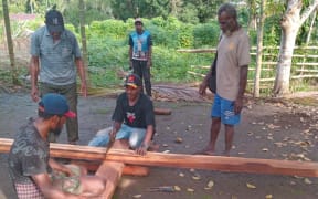 Indigenous Papuans in Merauke district protest to protect their customary lands. Crosses have been used as a protest symbol since 2010 when the Indonesian government launched the Merauke Integrated Food and Energy Estate project.