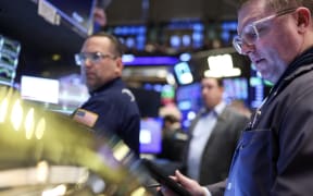 Traders work on the floor of the New York Stock Exchange (NYSE) at the opening bell in New York City, on April 3, 2025. Wall Street stocks sank in early trading on April 3,2025, joining a global equity selloff after President Donald Trump's latest tariff announcement exacerbated worries about a trade war and global economic downturn. (Photo by CHARLY TRIBALLEAU / AFP)