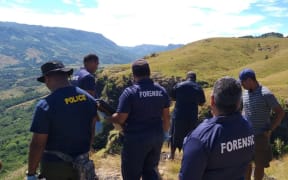 Police investigators in the Nausori Highlands following the deaths of  five members of the same family.