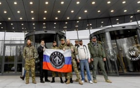 Members of Wagner Group stand outside new its new headquarters in St Petersburg in military camouflage , on November 4, 2022.