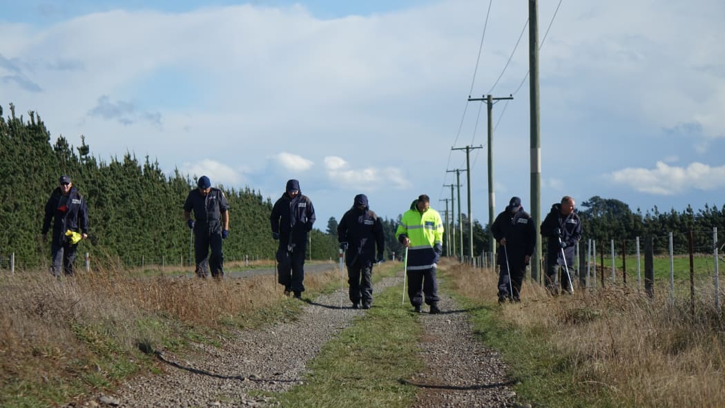 Police investigators canvass Main Rakaia Road, where the Renee Duckmanton's body was found.