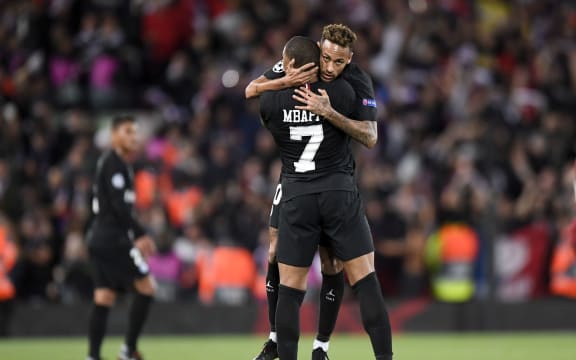 Kylian Mbappe and Neymar of Paris St Germain embrace.