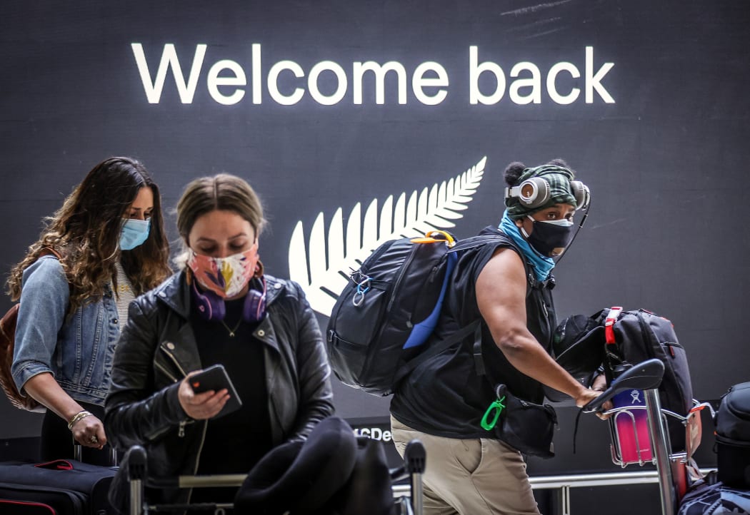 Passengers wearing masks arrive from New Zealand at Sydney International Airport on October 16, 2020.