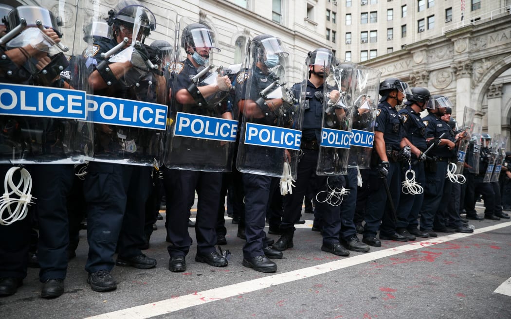 Police officers stand guard during Black Lives Matter protest as protesters locked down the streets by New York's City Hall and Police Plaza.