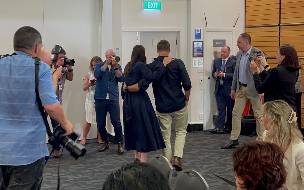 Jacinda Ardern (left) was greeted by her caucus after making the announcement that she was going to resign as prime minister.