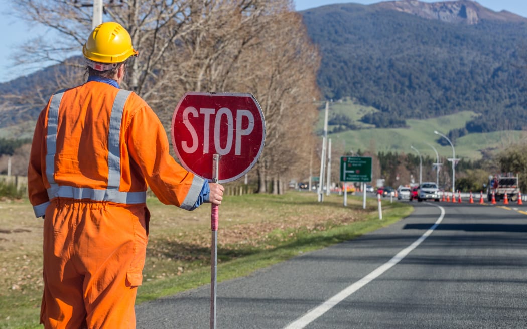Signs repairs road and worker