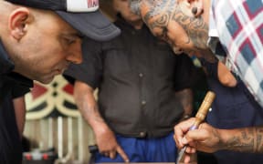 Toi Ngāpuhi expert Bernard Makoare explaining patterns to local carvers at a Whaiwhatawhata Marae wānanga funded by Creative New Zealand through the Te Awe Kōtuku programme.