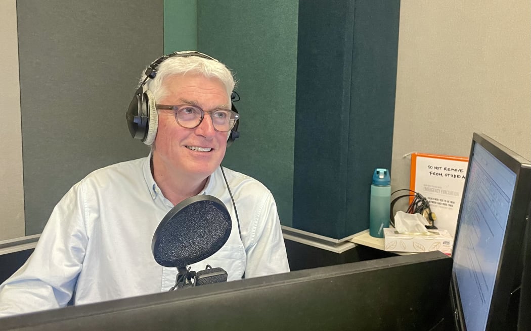 RNZ Nights host Mark Leishman speaks into the microphone while presenting the show.