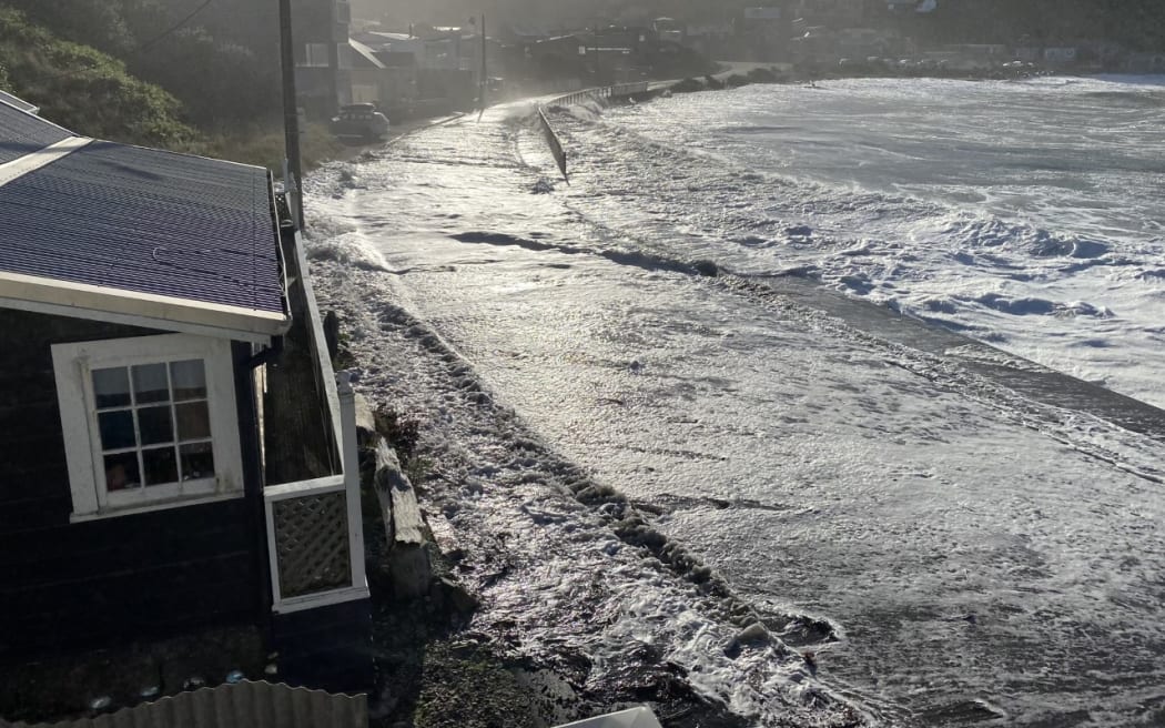 Swells come up onto the road and threaten Ōwhiro Bay homes in Apirl 2020.