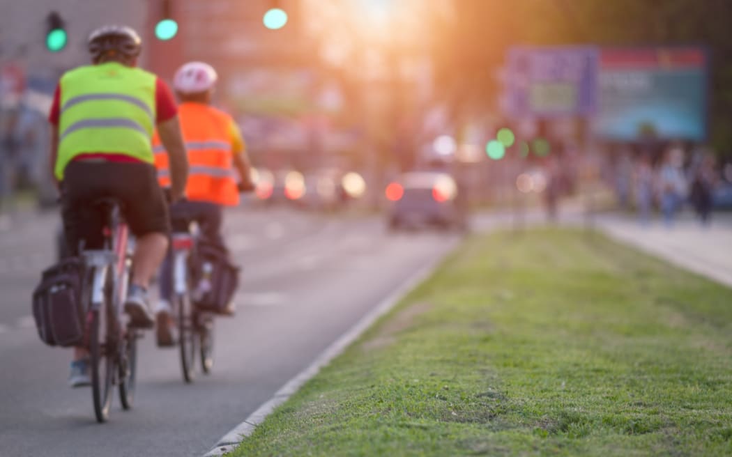 Urban commuters biking on a city street.