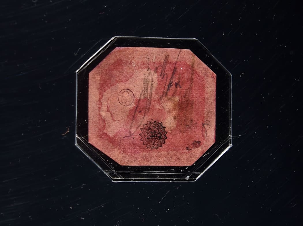 The reverse side of the British Guiana One-Cent Magenta, described as the most famous stamp in the world, on display in a glass case at Sotheby's June 17, 2014 in New York.