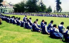 School girls wait outside the Royal Palace in Tonga