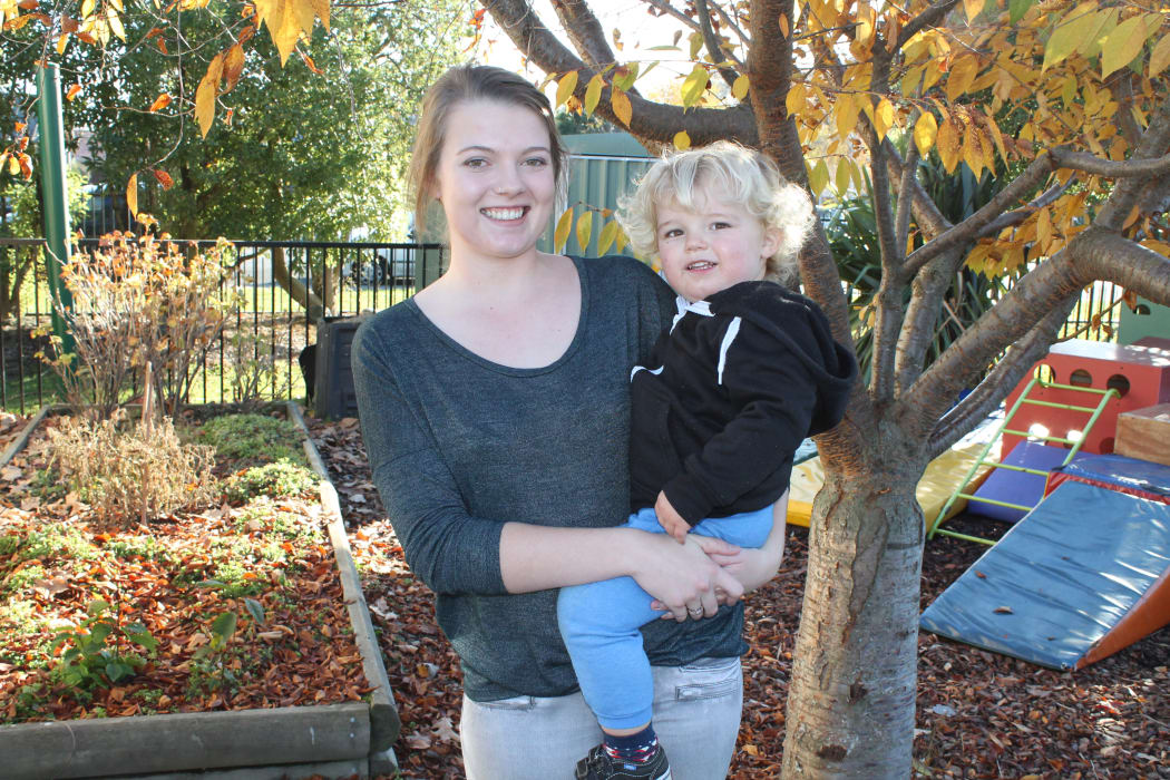 A photo of Brooke Gray and her son, Max, in the creche garden at Karanga Mai Young Parents College