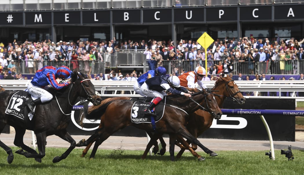 Jockey Craig Williams onboard Vow and Declare, followed by Frankie Dettori on Master of Reality and and at the far left, Michael Walker on Prince of Arran.