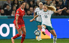 New Zealand's forward #16 Jacqui Hand (R) fights for the ball with Switzerland's midfielder #06 Geraldine Reuteler (L) during the Australia and New Zealand 2023 Women's World Cup Group A football match between Switzerland and New Zealand at Dunedin Stadium in Dunedin on July 30, 2023. (Photo by Sanka Vidanagama / AFP)
