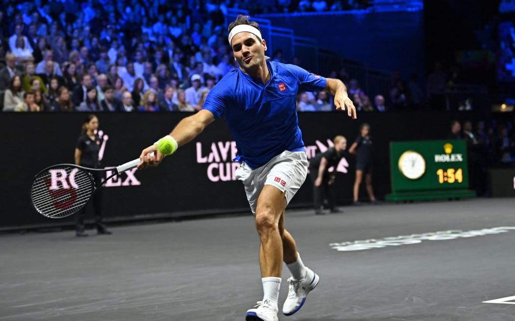 Switzerland's Roger Federer playing with Spain's Rafael Nadal of Team Europe returns against USA's Jack Sock and USA's Frances Tiafoe of Team World during their 2022 Laver Cup men's doubles tennis match at the O2 Arena in London, early on September 24, 2022.