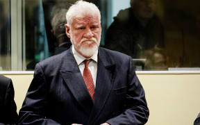 Former general Slobodan Praljak stands prior to the start of his appeal judgement at the International Criminal Tribunal.