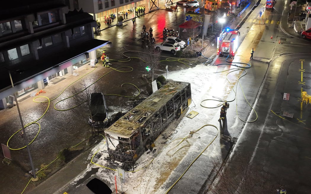 This handout picture taken an released on March 10, 2026 by the Canton of Fribourg shows the main street of the small town of Kerzers where a bus caught fire, killing at least six people and injuring five others in what police said may have been a deliberate act. A bus caught fire in western Switzerland on March 10 killing at least six people and injuring five others in what police said may have been a deliberate act. The fire broke out on the bus in the main street of the small town of Kerzers, around 20 kilometres (12 miles) west of the Swiss capital Bern, at about 6:25 pm (1725 GMT). (Photo by Handout / Etat de Fribourg - Staat Freiburg / AFP) / RESTRICTED TO EDITORIAL USE - MANDATORY CREDIT "AFP PHOTO /  CANTON OF FRIBOURG / STAAT FREIBURG" - HANDOUT - NO MARKETING NO ADVERTISING CAMPAIGNS - DISTRIBUTED AS A SERVICE TO CLIENTS