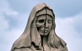 stone statue with skull