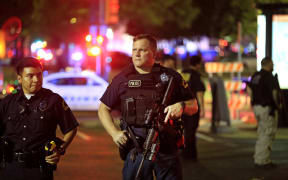 Dallas police stand watch near the scene where four Dallas police officers were shot and killed on July 7, 2016 in Dallas, Texas.