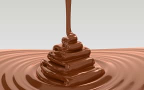 A stream of melted chocolate forms a tower.