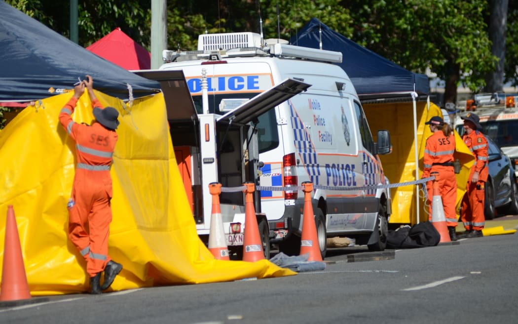 Emergency services cordon off the house where the bodies of the children were found.