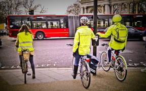 Cyclists in London staying safe by wearing high-visibility jackets. (Taken using my mobile phone.)