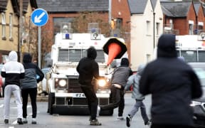 Nationalist youths attack police officers in the Springfield Road area of Belfast on April 8, 2021 as disorder continued in the Northern Ireland capital following days of mainly loyalist violence. -