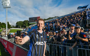 Francis de Vries of Auckland FC takes a selfie with fans, supporters and crowd.