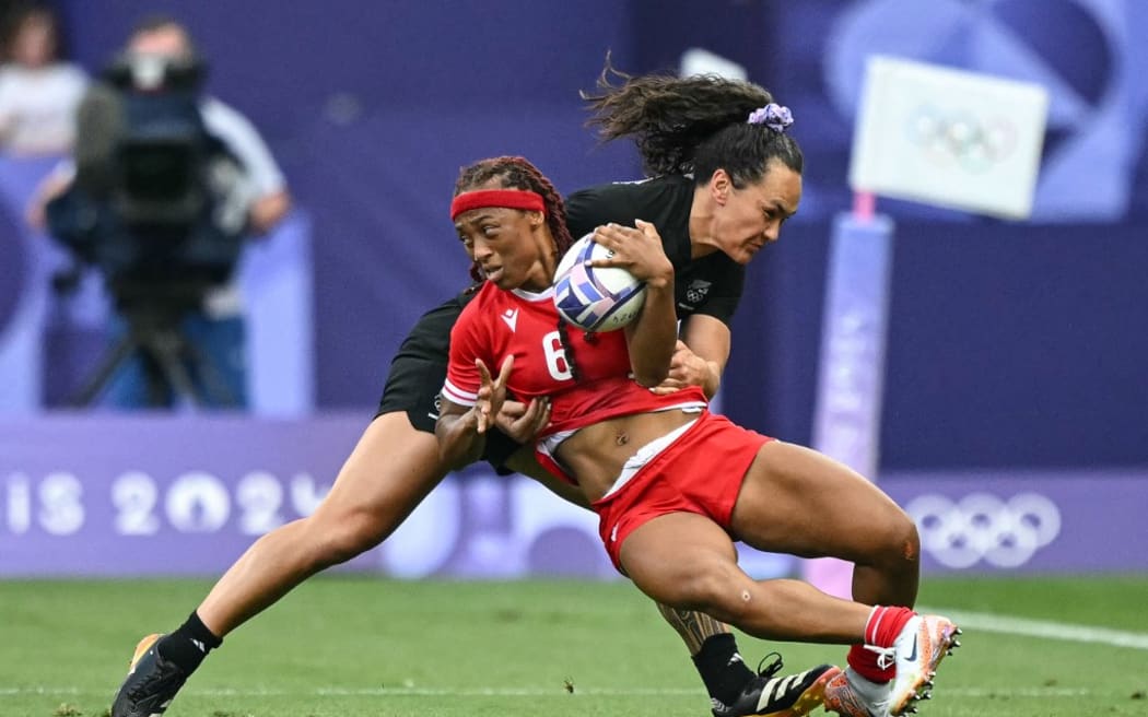 Canada's Charity Williams is tackled by New Zealand's Portia Woodman-Wickliffe during the women's gold medal rugby sevens match between New Zealand and Canada during the Paris 2024 Olympic Games at the Stade de France in Saint-Denis on July 30, 2024.