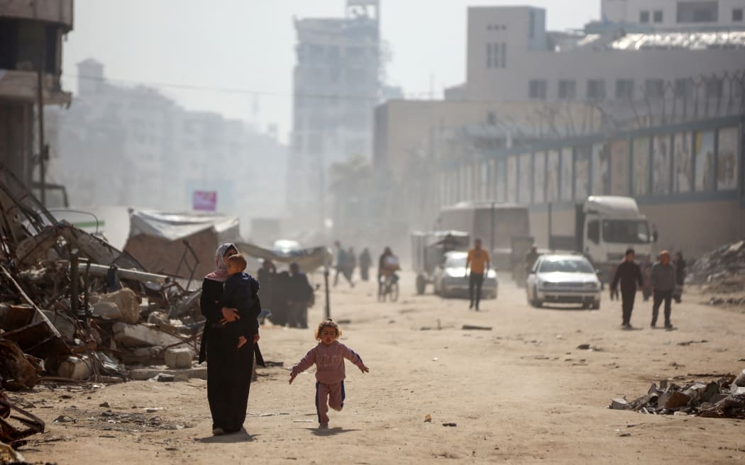 Palestinians walk among the rubble of homes in Gaza, on March 17, 2025. (Photo by Majdi Fathi/NurPhoto) (Photo by MAJDI FATHI / NurPhoto / NurPhoto via AFP)