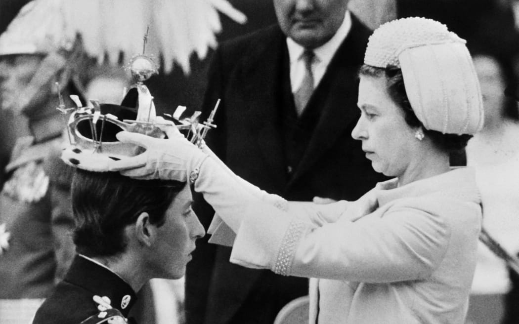Queen Elizabeth II puts a crown on his son Prince Charles during his investiture as new Prince of Wales in Caernarfon, on 1 July 1969.
