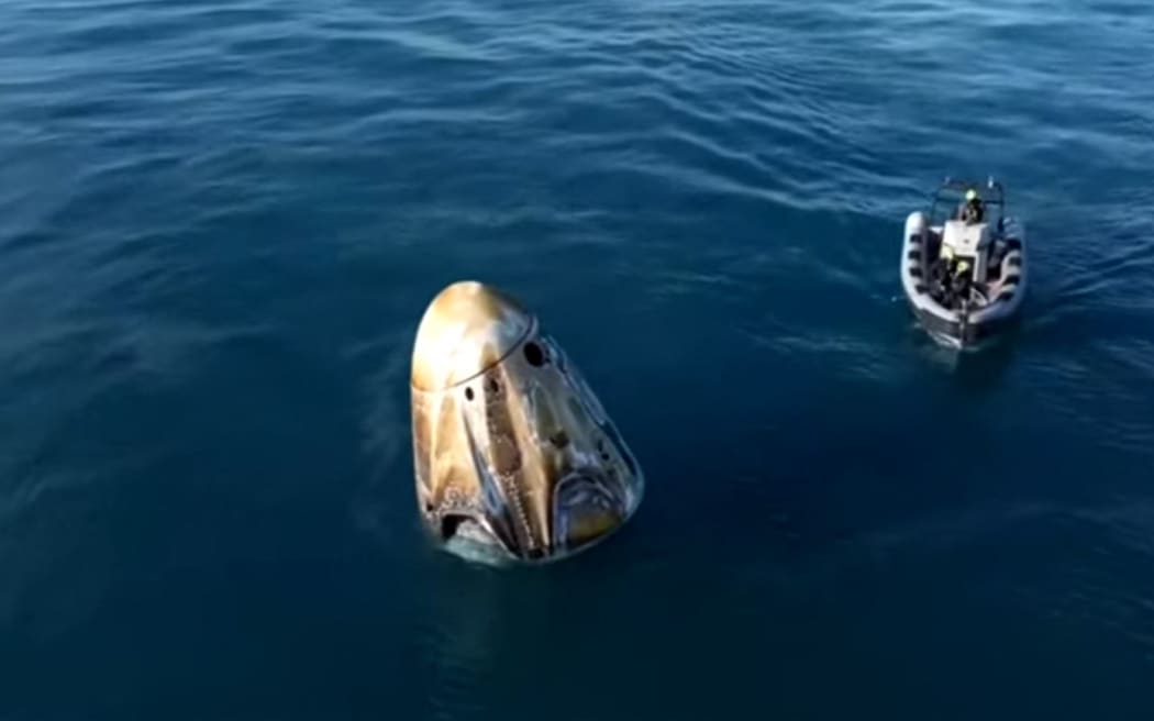 This still image from a NASA+ livestream shows a recovery vessel approaching the Dragon capsule with the SpaceX Crew-9 astronauts shortly after splashdown on March 18, 2025, off the coast of Florida. The SpaceX craft is returning stranded astronauts Butch Wilmore and Suni Williams. They are joined onboard by NASA's Nick Hague and Russian cosmonaut Aleksandr Gorbunov. (Photo by Handout / NASA+ / AFP) / RESTRICTED TO EDITORIAL USE - MANDATORY CREDIT "AFP PHOTO / NASA+" - NO MARKETING NO ADVERTISING CAMPAIGNS - DISTRIBUTED AS A SERVICE TO CLIENTS