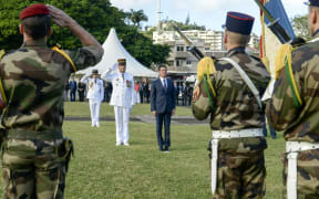 French Commander of the French Armed Forces in New Caledonia, Major General Philippe Leonard, (L) and French Prime Minister Manuel Valls salute at the place Bir-Hakeim in Noumea during a wreath lane ceremony at the wall memorial on April 29, 2016.