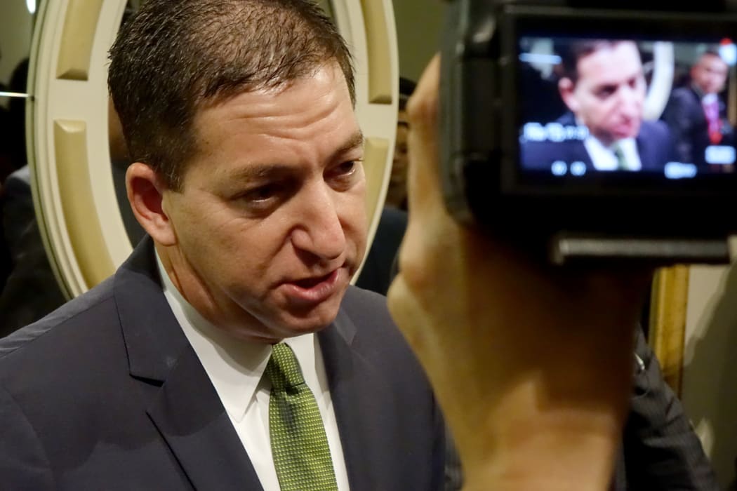 Journalist Glenn Greenwald responds to media after a news conference.